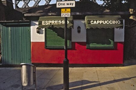 fotografija rdeče, bele take away kavarne, z zelenimi roloji na oknih in napisoma espresso , cappuccino